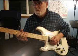 Dan playing electric guitar