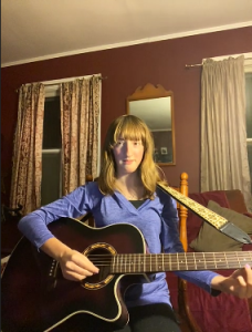 Amalie playing guitar