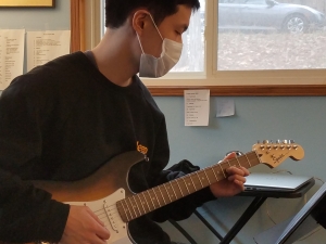 Cheol, student playing guitar