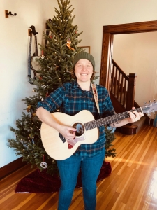 Heather, student playing guitar