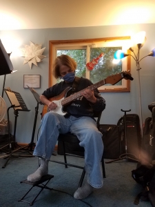 Hilary, student playing guitar