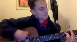 Chris, student playing guitar