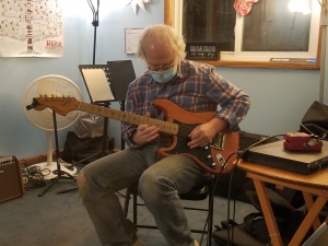 Dan, student playing guitar