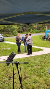 mingling people on sidewalk Student party 2023