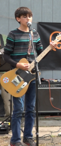 kid taking guitar lessons