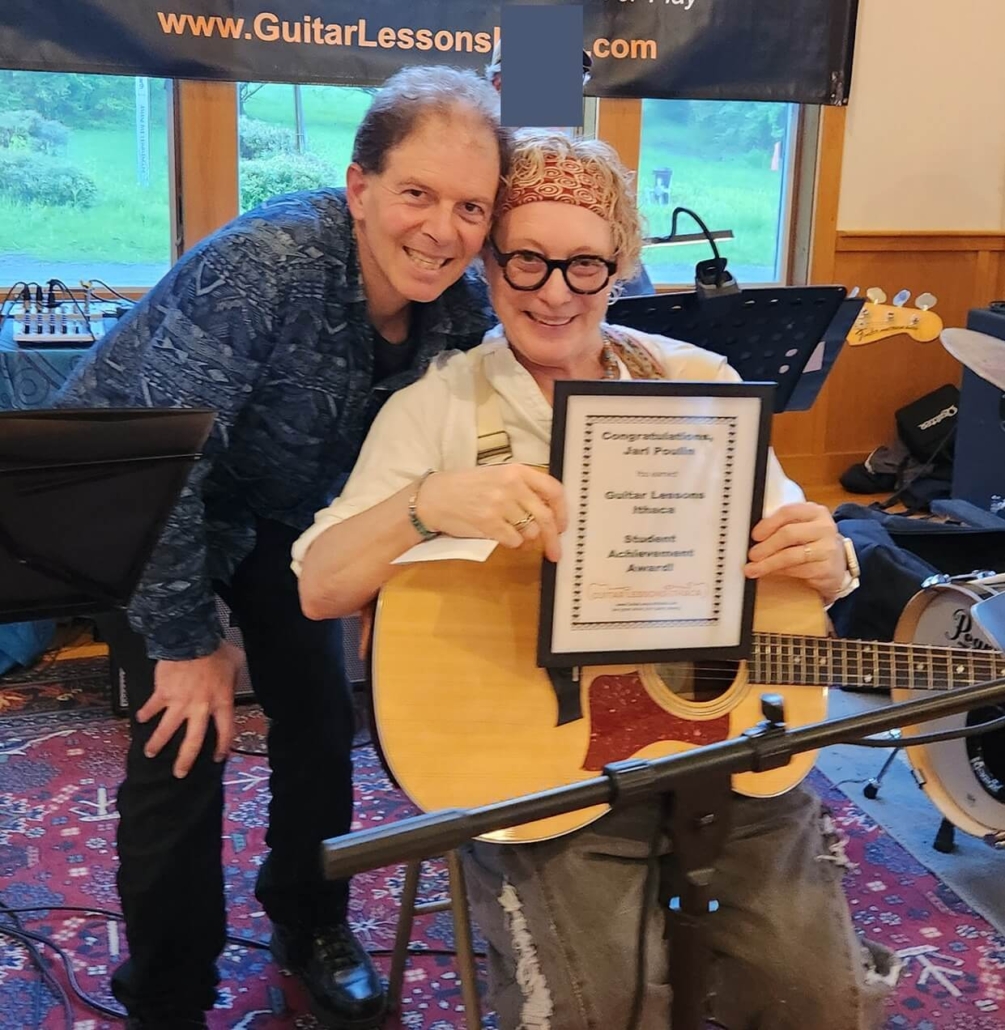 Jari receiving student achievement award, with Dennis next to her